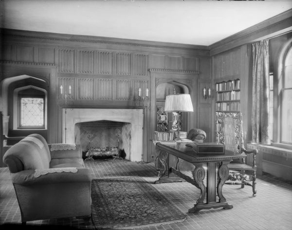 This room in the home of William Llewellyn and Zone Gale Breese, with desk, wood paneled walls, fireplace, and tile floor served as Ms. Gale's study.