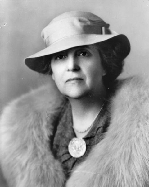 Portrait of Pulitzer Prize winning author Zona Gale wearing a hat and a coat with a fur collar.