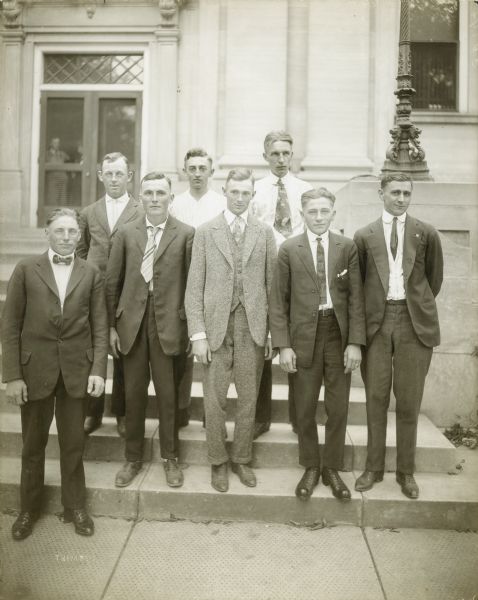 Eight men drafted to serve in World War I stand on the steps of the Sauk County Courthouse. They would leave that day for the newly constructed Camp Grant, south of Rockford, Illinois.