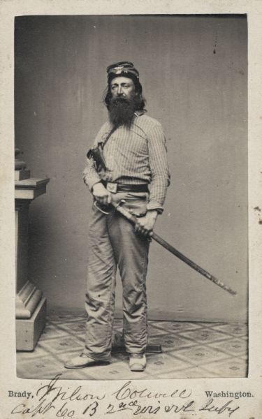 Full-length carte-de-visite portrait of Captain Wilson Colwell, Company B, 2nd Wisconsin Infantry, with revolver and sword. Colwell was killed in action at South Mountain, Maryland on September 15, 1862.