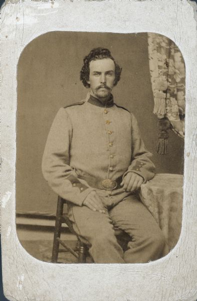 Seated carte-de-visite portrait of Silas Stewart, Company B, 8th Wisconsin Infantry. Stewart enlisted in 1861 and served until the end of the war without being injured.