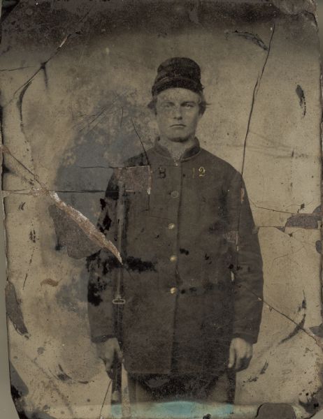 Three-Quarter length portrait of Charles W. Gulliford, Company B, 12th Wisconsin Infantry, with musket. Photograph was taken at Camp Randall.
