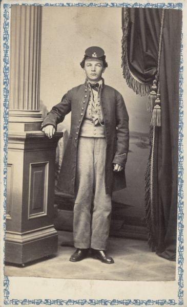 Full-length carte-de-visite portrait of A. Rollins from River Falls, Wisconsin in Civil War era uniform. His company and regiment are unknown.