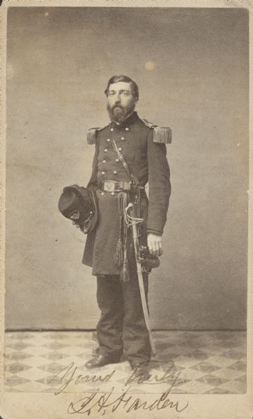 Full-length carte-de-visite portrait of Lieutenant Colonel James A. Farden, F & S, 54th Ohio Infantry, in uniform with epaulettes. He has a sword on his left side. He accepted appointment as Major in the 54th Regiment on September 27, 1861.