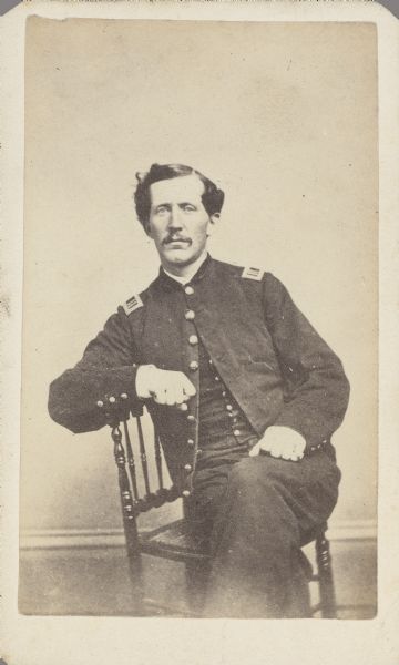 Seated carte-de-visite portrait of Captain Charles H. Fenn, Company F, 28th New York Infantry, in uniform.