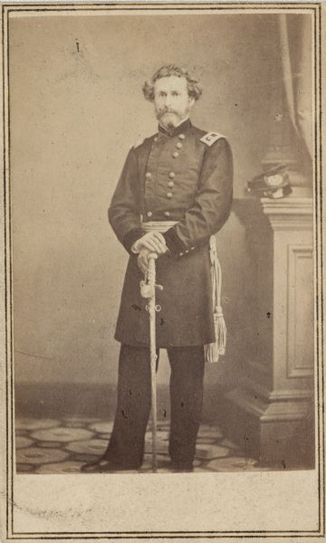 Full-length carte-de-visite portrait of Major General John C. Fremont in full officer uniform, holding his sword in front. During the war he commanded the Department of the West.