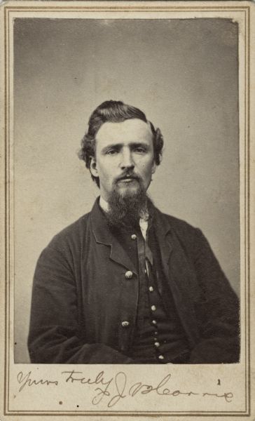Seated waist-up carte-de-visite portrait of Private J. Harris. His regiment and company are not known.