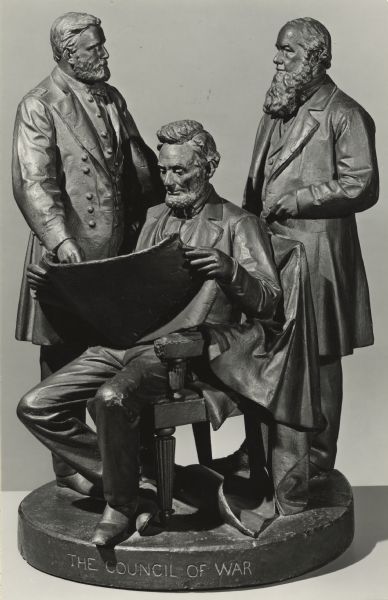 Photograph of the sculpture "The Council of War" by John Rogers (1829-1904). From left to right: General Ulysses S. Grant, Abraham Lincoln, and Secretary of War Stanton. The group is signed on top of the base, John Rogers, New York; additionally inscribed on the edge of the base, "The Council of War". The sculpture is in the collections of the Toledo Museum of Art, Toledo, Ohio, and dated 1868.

