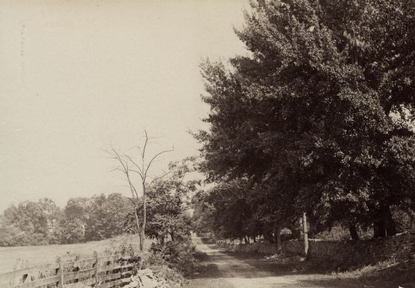 Hagerstown Pike. A brick wall and trees are along the road on the right.