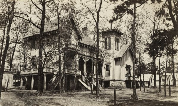 General John H. King's headquarters while troops under his command occupied the site in 1864-1865. General King did not participate in the Battle of Lookout Mountain, November 23-25, 1863, as he was sick at the time, but the 2nd Brigade, First Division, 14th Army Corps, his regular command, did take part in the engagement. Later, an occupation force, consisting of the 15th, 16th, 18th and 19th regiments of the U.S. Army regulars, had headquarters here, in conjunction with hospital buildings built during 1864-1865. The hospital eventually became the site of the Lookout Mountain Educational Institutions (1866-1872). Men in uniform are standing on the steps to the elevated porch.