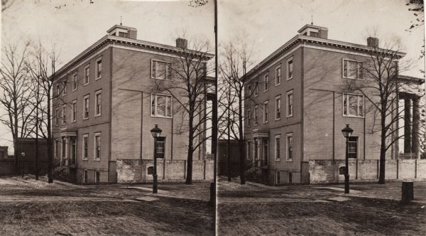 Stereograph of exterior of a building used as the Confederate government's Executive Mansion. This was where Jefferson Davis and his family stayed during the Civil War. After the war, the building was used as the Richmond Central School. The sign above the door says Central School.