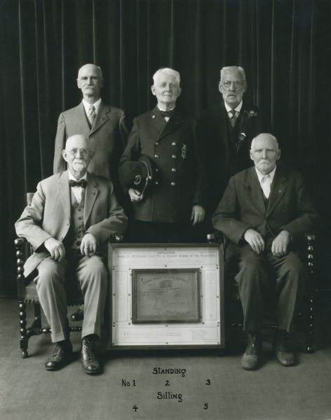 Portrait of the five surviving members of the Grand Army of the Republic, John H. Williams, Post No. 4. Standing from left to right around the framed charter are: William Eldred, Commander George W. Morton, and Frank D. Murdock. Seated from left: Alexander Parsons and Henry L. Marsh.