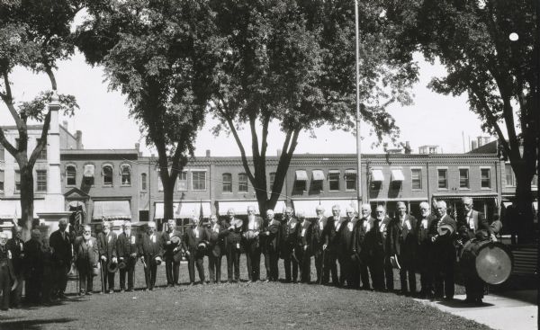 Outdoor group portrait of some of the members of the Grand Army of the Republic at a reunion.