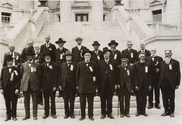 Group portrait of the members of the Grand Army of the republic at a reunion. The group appears to be posing on the steps of the Wisconsin State Capitol.