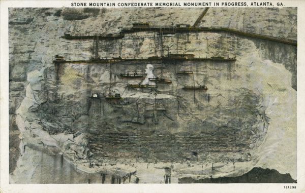 A colored postcard showing the Stone Mountain Confederate Memorial at an early stage of the bas-relief carving. Caption reads: "Stone Mountain Confederate Memorial Monument in Progress, Atlanta, GA."
