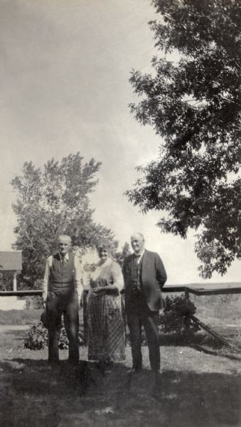 Katherine (Kate) Quinney and her brothers, Thomas (Tom) and Willam (Bill), standing in a yard.