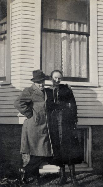 Lloyd Latta and Marjorie Quinney pose for a picture in front of the Latta house.