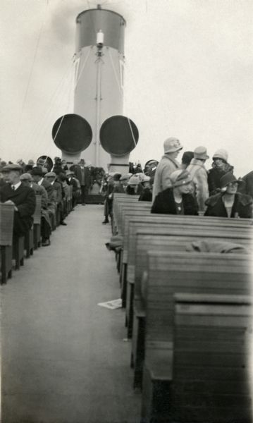 View of smokestacks and seated passengers on the deck of the <i>Avalon</i> traveling to Catalina Island.
