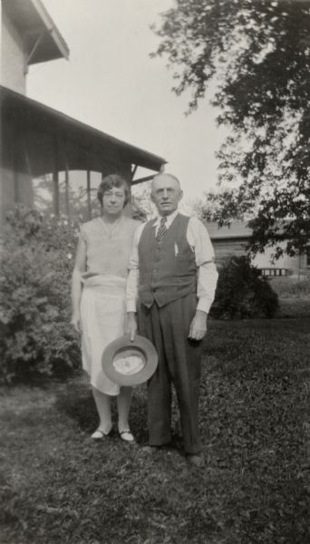 Will Holloway and Mabel Stiles Holloway, Alice Quinney's father and step-mother, pose for a photograph in their yard on Alice's wedding day.