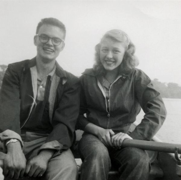 Richard Quinney and Peggy (?) pose for a snapshot in a rowboat on a lake.