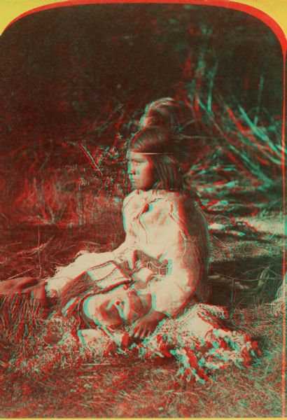 Stereograph of a Native American young woman, a Ute Indian, in traditional costume.