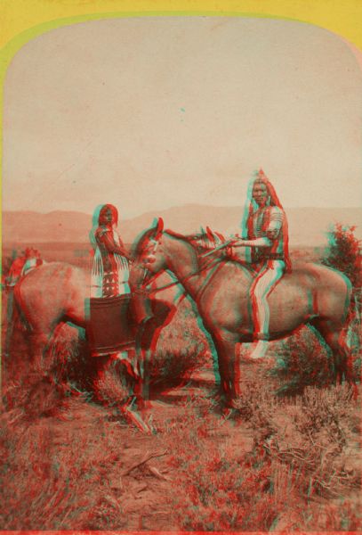 Stereograph of a Native American man and woman, both Ute Indians, on horseback.