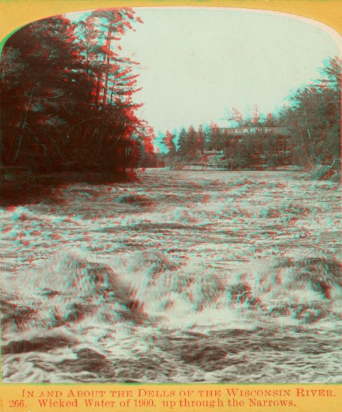 Stereograph of a turbulent portion of the Wisconsin River known as the Wicked Water, up through the Narrows. The roof of the Larks Hotel, with the hotel's name on it, is in the background.
