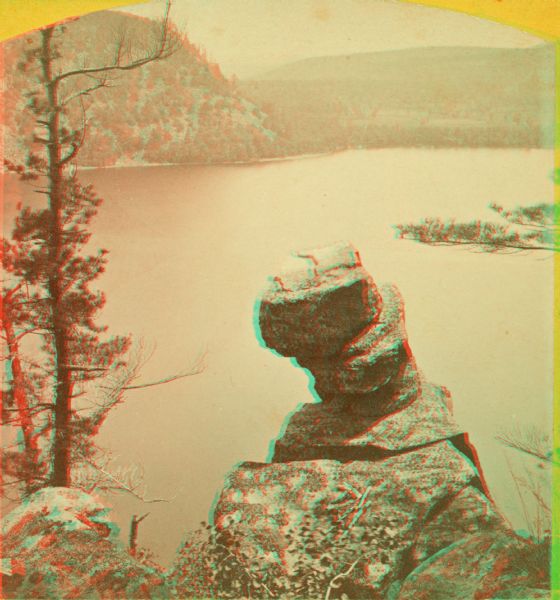 Stereograph over Devil's Lake with Turk's Head rock formation in the foreground.