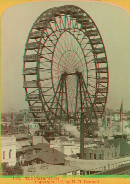 Stereograph over rooftops towards the Ferris wheel at the Chicago World's Fair.
