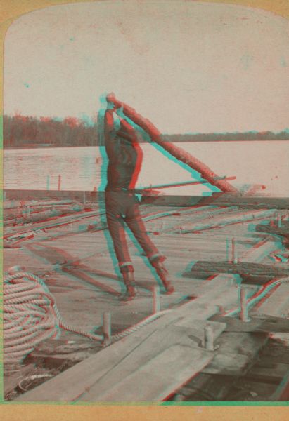 Stereograph of photographer Henry Hamilton Bennett pulling an oar on a Wisconsin raft.
