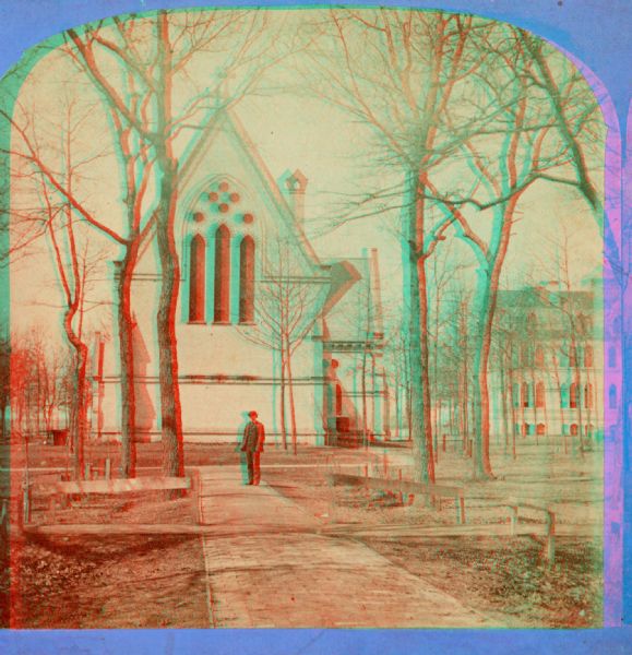 Stereograph of a chapel on the campus of Racine College with a man standing in front of it.