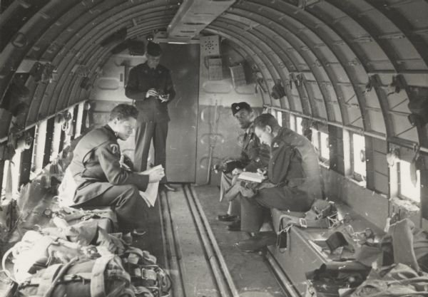 Sigurd F. Olson, standing, on a C-47 plane en route from Berlin to Frankfort, and then home to Minnesota.