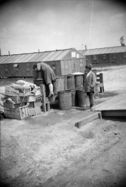 Snapshot taken by Sigurd Olson of refugees scavenging in military trash bins. Although the location is not identified, it is probably in or near Berlin.