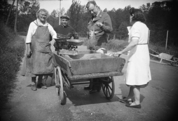 American soldier purchasing something from a food cart, a scene photographed by conservationist Sigurd Olson while traveling in Europe immediately after the end of World War II.