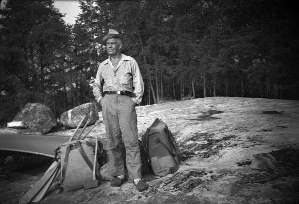 Sigurd Olson, in typical camping attire, during a canoe trip at Quetico Park in Canada.