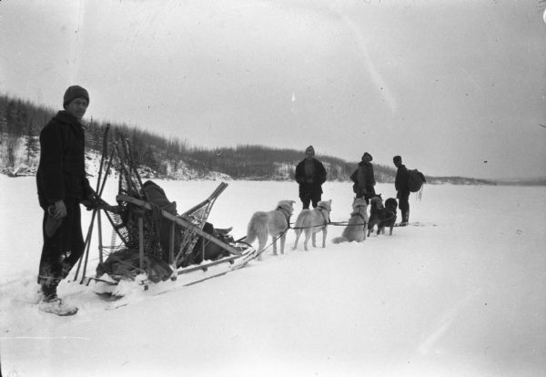 Sigurd Olson, left, traveling by dogsled with game hunter Uiho Salminen as part of his study of predator control for his master's degree.