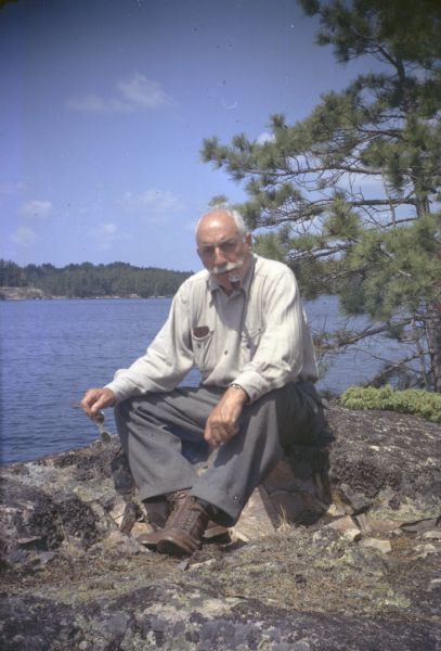 Publisher Alfred A. Knopf, Sr., photographed while visiting the cabin of author Sigurd Olson at Listening Point. Knopf published all eight of Olson's books, and he was well-known for the personal relations he developed with his authors.