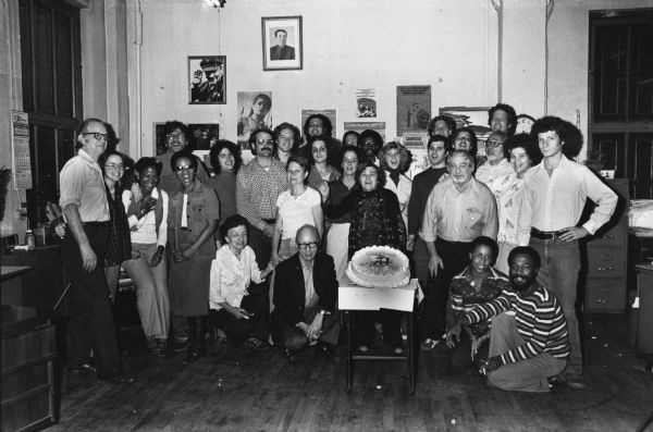 Staff of the "Guardian," the Marxist-Leninist weekly newspaper, taken on the 40th anniversary of the paper's establishment. The cake is decorated with a hammer and sickle.