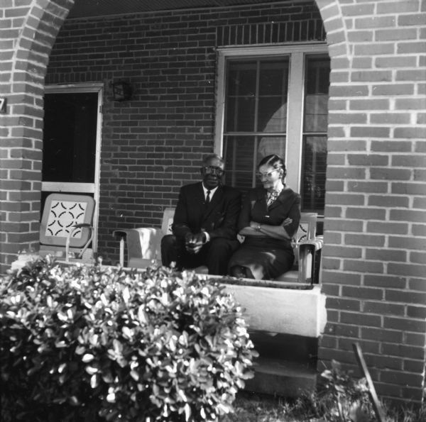Civil rights leader Ed Nixon, and his wife, seated on the front porch of their home.