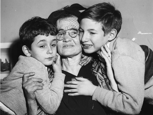 After their parents' arrest, Robert (left) and Michael Rosenberg had no settled home. They were eventually placed with Abel and Anne Meeropol under the provisions of the Rosenberg's will, but not without court action by their grandmother Sophie Rosenberg. The three are seen here after a judge temporarily placed the boys with Mrs. Rosenberg.