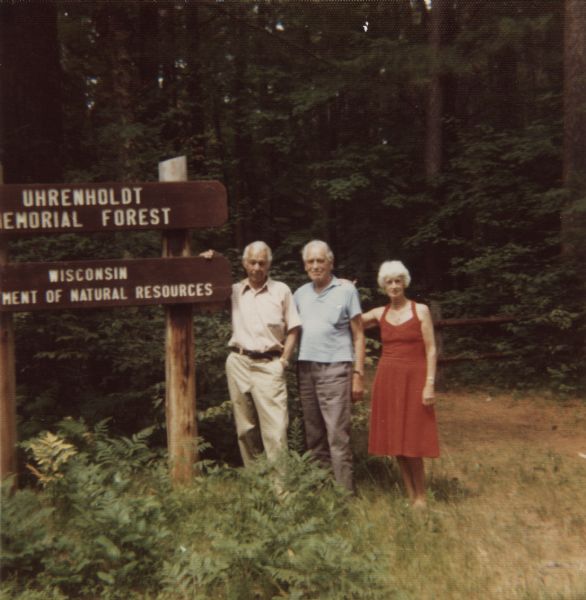 Marker at the Uhrenholdt Memorial Forest established by farmer Soren J. Uhrenholdt on land that was part of northern Wisconsin's "Cutover Region." A leader in sustainable farming and forestry, Uhrenholdt's property was donated to the state. In the photograph are conservationist Sigurd Olson, who married Uhrenholdt's daughter, and two of her siblings.