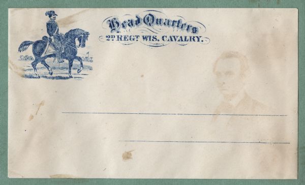 A cavalry soldier sits on his horse, with a military camp and flag in the background. The faint image of Abraham Lincoln is from the opposite envelope in the album. To the right in fancy type is the text, "Head Quarters 2D REGT. WIS. CAVALRY." Blue ink on beige envelope, image in upper left corner. Image printed on envelope, mounted on various colored pages and collected in an album.