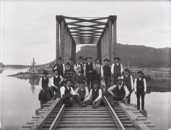 A railroad section crew poses with a handcar on the trestle spanning the Buffalo River, north of Alma, Wisconsin.