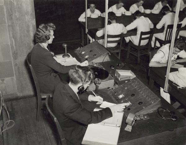 Two instructors, Beatrice and Leon Lamoreux, teaching Naval students telegraphy at the U.S. Naval Training School (Radio).