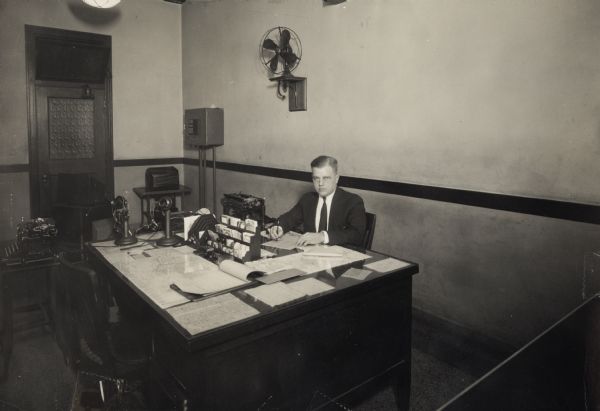 Leon Lamoreux sits at his desk in the Western Union office at 21 West Main Street. (This building no longer exists.) He and his wife, Beatrice, later taught typing and telegraphy at the U.S. Naval Training School (Radio) in Madison.
