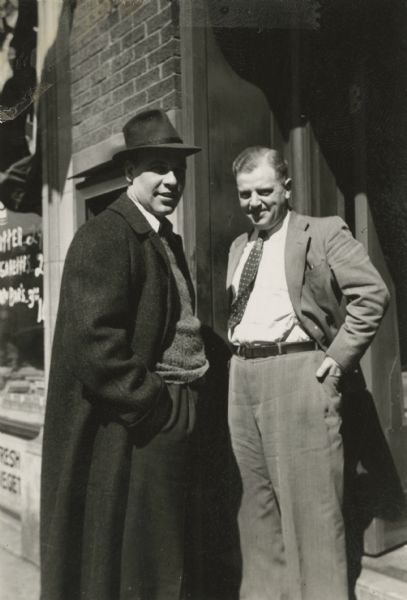 Leon Lamoreux (on the right) and an unidentified man stand outside of the Western Union Branch Office doorway, 650 State Street. The date is between 1937 and 1941. The store on the left is the State Street Food Store, (now Einstein Bros. Bagels). On the right is the Western Union Branch Office, (now Expresso Royale Cafe). During World War II, Leon and his wife, Beatrice, will teach typing and telegraphy to Naval students at the U.S. Naval Training School (Radio) in Madison.