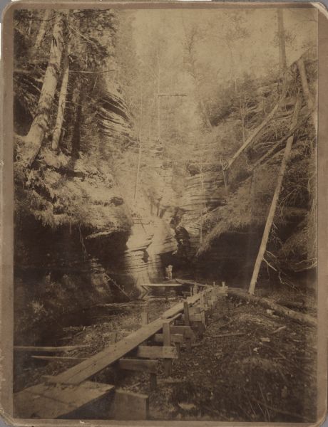 Entrance to Cold Water Canyon near Wisconsin Dells. In the foreground is a wooden walkway across the water.