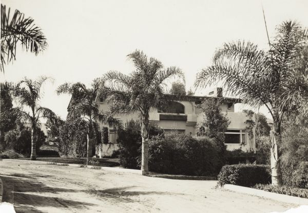 View from street of Blanche and Will Henry McFetridge's home in San Diego with palm trees in front.
