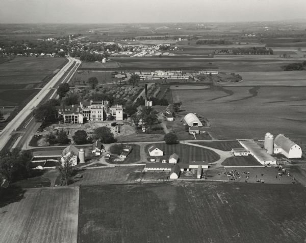 Aerial view of the Dane County Hospital, looking west. Excavating for a more modern east wing that was finished in 1960 can be seen near the main building. It had been called the Dane County Asylum for the Criminally Insane. In 1880 it became a part of the county hospital system, which was set up to provide longer term care to people who were discharged from the state hospital system.