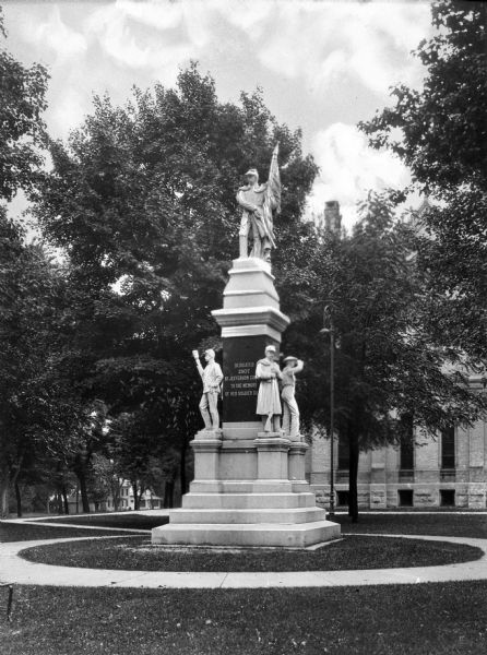 View of the Civil War Soldiers' Monument. The monument on the courthouse grounds is surrounded by a walkway and trees.